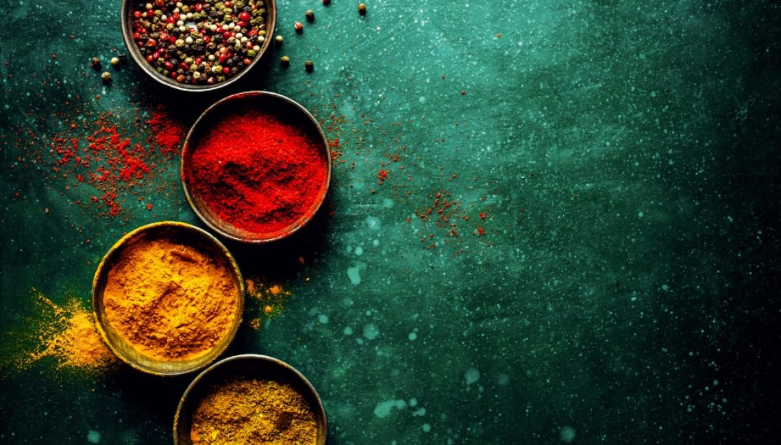 colorful-spices-on-dark-table-min