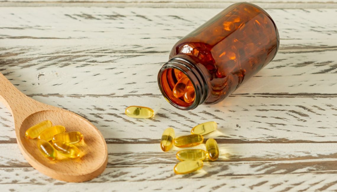 fish-oil-capsules-on-wooden-background-and-texture-vitamin-d-omega-supplement-selective-focus-min